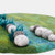 Felted balls on a textured green surface