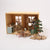 Miniature dollhouse with furniture and decorative items on a white background