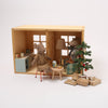 Miniature dollhouse with furniture and decorative items on a white background