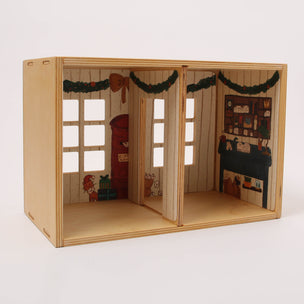 Wooden dollhouse with decorated interior on a white background