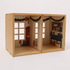 Wooden dollhouse with decorated interior on a white background