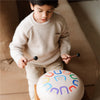 Child playing the Tambú 10" Soul Serenity