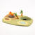 Felted landscape with a campfire, trees, and a pond on a white background