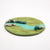 Round felted landscape with green and blue colors on a white background