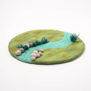 Round felted mat with green and blue gradient, decorative elements, and a white background