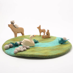 Felted play mat with animal figures on a white background