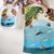 Children's play mat with ocean scene and toys on a light-colored surface