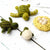 Felted turtle toys and a nest with eggs on a white wooden surface