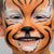 Child with tiger face paint on a plain background