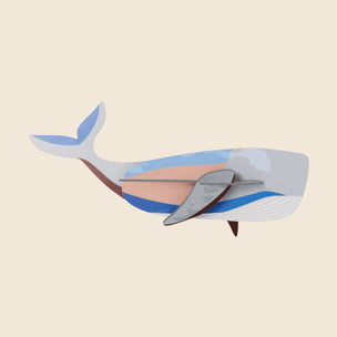 Colorful whale-shaped clock on a beige background