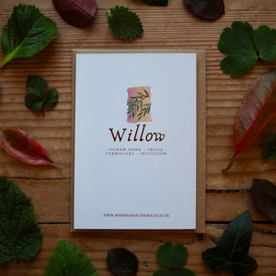 Card with 'Willow' design on a wooden surface with leaves
