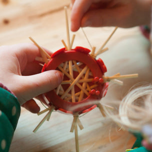 Child making 8 pointed straw star using this simple kit