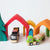 Grimm's House with Ostheimer Spruce & Plan Toys Trucks | Conscious Craft