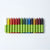 A set of 15 different coloured crayons for drawing on fabric pictured from white through the rainbow colours, plus a few extra, to black. Made by ökoNORM Wax Fabric Crayons | © Conscious Craft