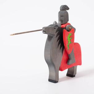 Black knight on horse with green dragon on red shield | © Conscious Craft