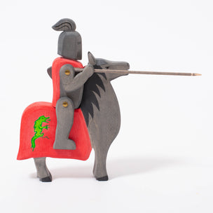 Wooden toy knight riding black horse with red cover and dragon emblem | © Conscious Craft