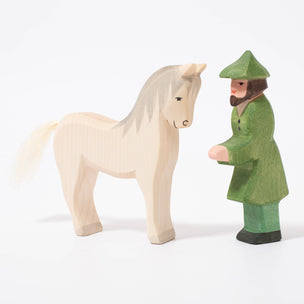 Wooden toy figure of hunter in green with white horse from Ostheimer | ©Conscious Craft
