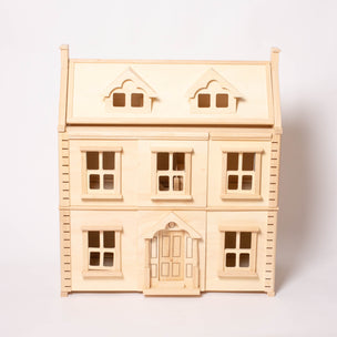 Large wooden Plan Toys Victorian Dollhouse with 3 floors and 2 dormer windows in the roof | © Conscious Craft